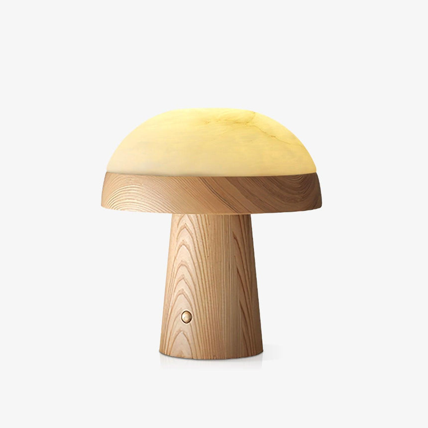 Stone table lamp with a light wood base lit, the dome glowing