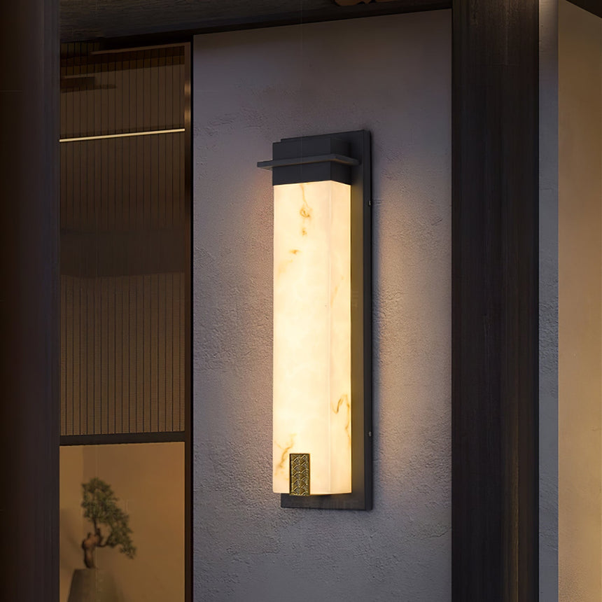The light on a textured render wall beside a fluted timber panel