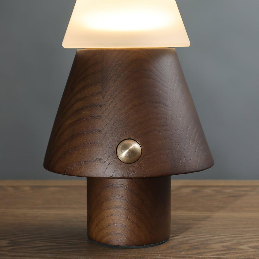 Close view of the turned wood cone base and its brass button