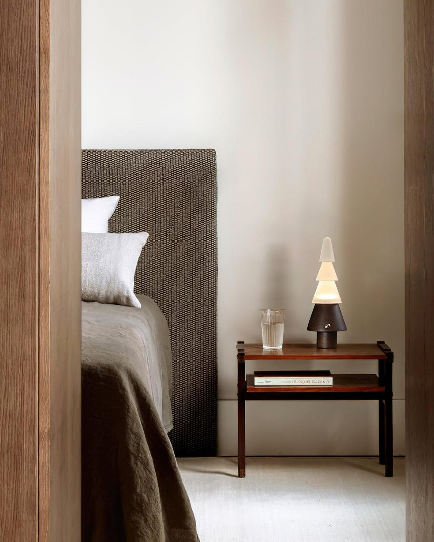 Table lamp with night light lit on a nightstand in a gray bedroom