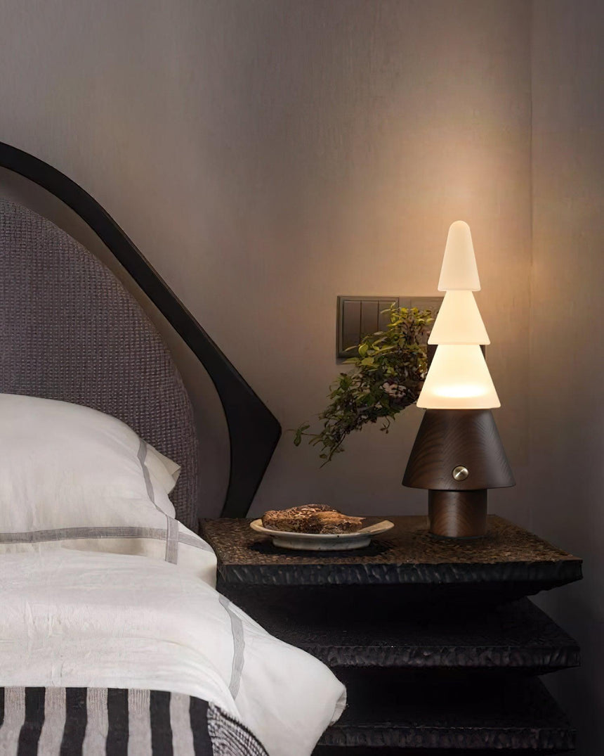 Table lamp with night light lit on a nightstand beside a small tray