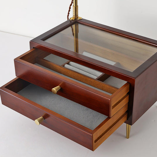 The two lined drawers of the lamp pulled open below the glass top panel