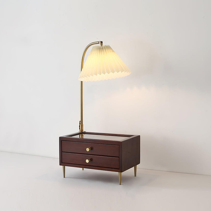 Table lamp with storage switched on against a plain pale background