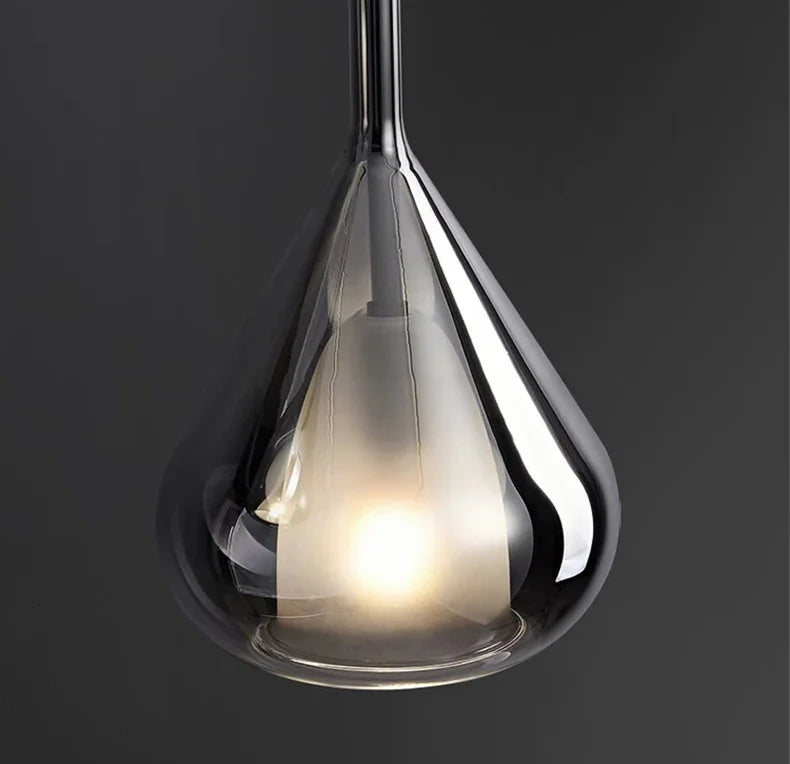 The lit teardrop against a dark wall showing the mirrored chrome surface