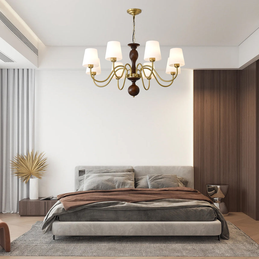 The cones lit above a low bed with dried grasses in a vase beside