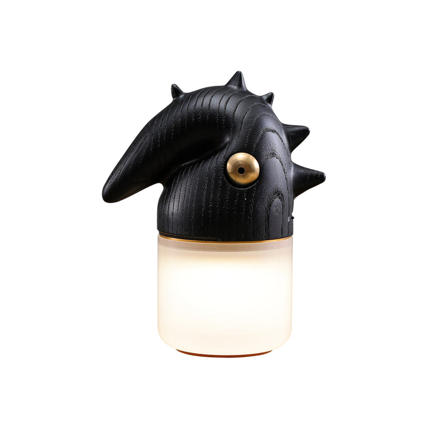 Black touch control bedside lamp lit, seen at an angle