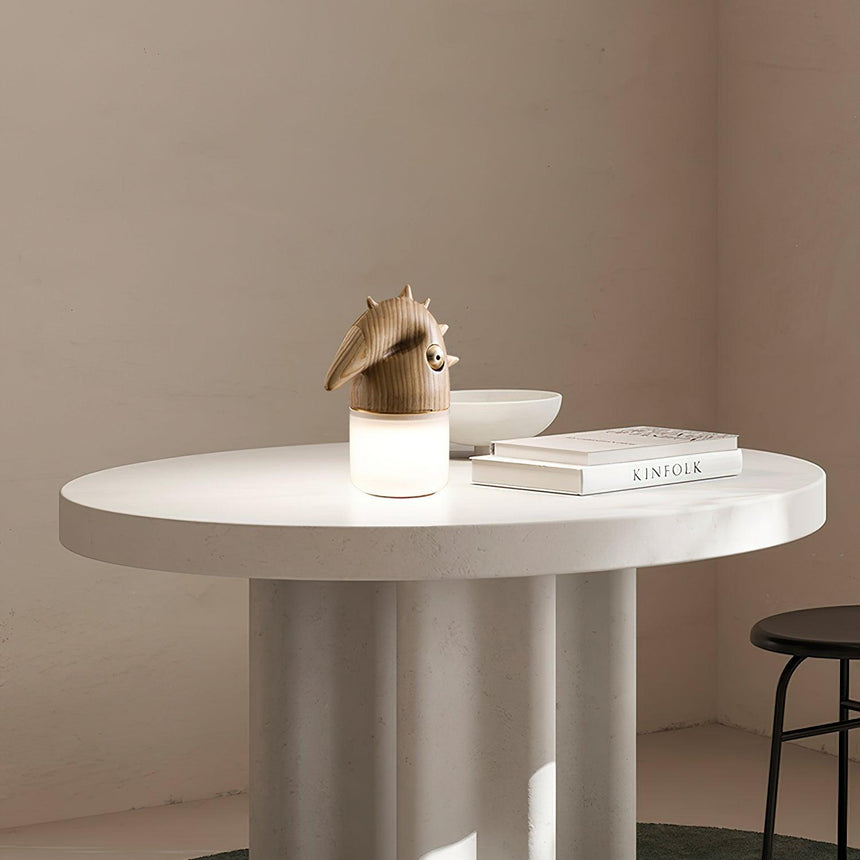 Natural wood touch control bedside lamp lit on a round table
