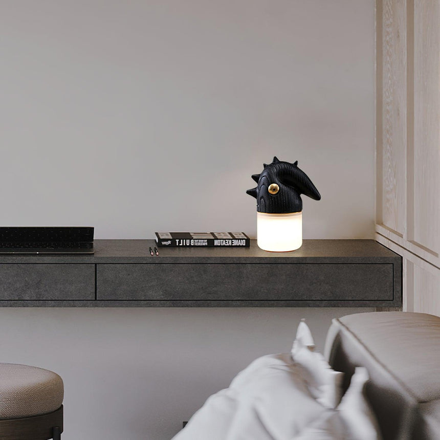 Touch control bedside lamp lit on a concrete ledge in a bedroom