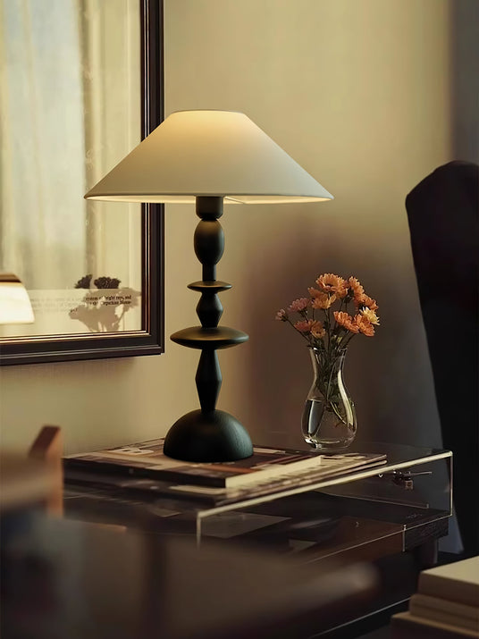 Turned spindle table lamp seen from an angle, the disc turnings visible