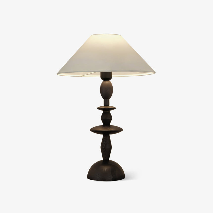 Traditional table lamp with a turned spindle base and a wide linen shade