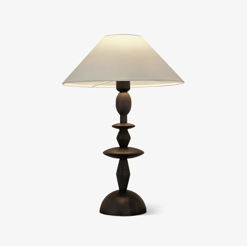 Turned spindle table lamp seen front on with the shade slightly above