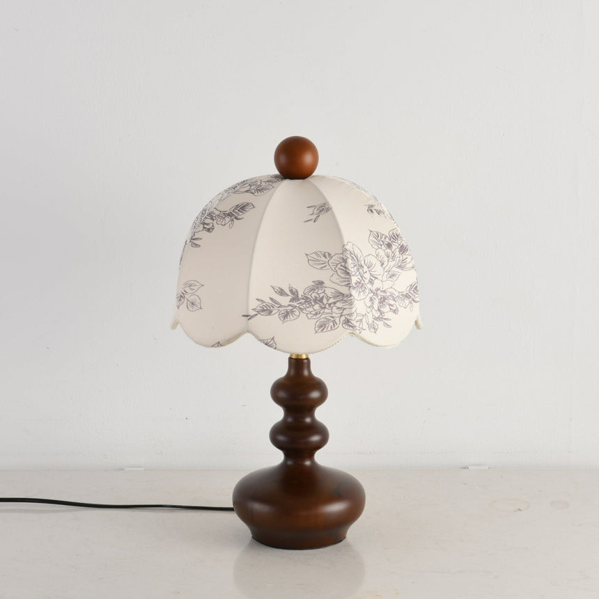 Side view of the lamp showing the turned base and the scalloped hem