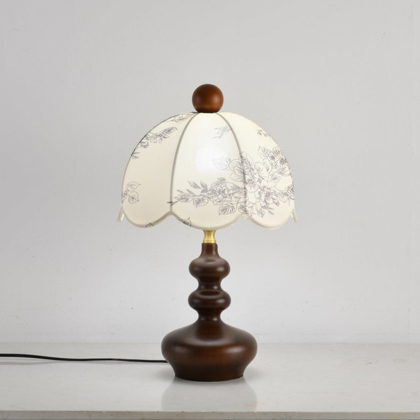 Scalloped toile shade lamp unlit seen from a slight angle
