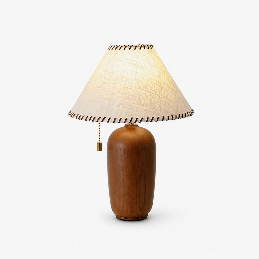 Traditional table lamp with a cream woven shade on a turned wood body