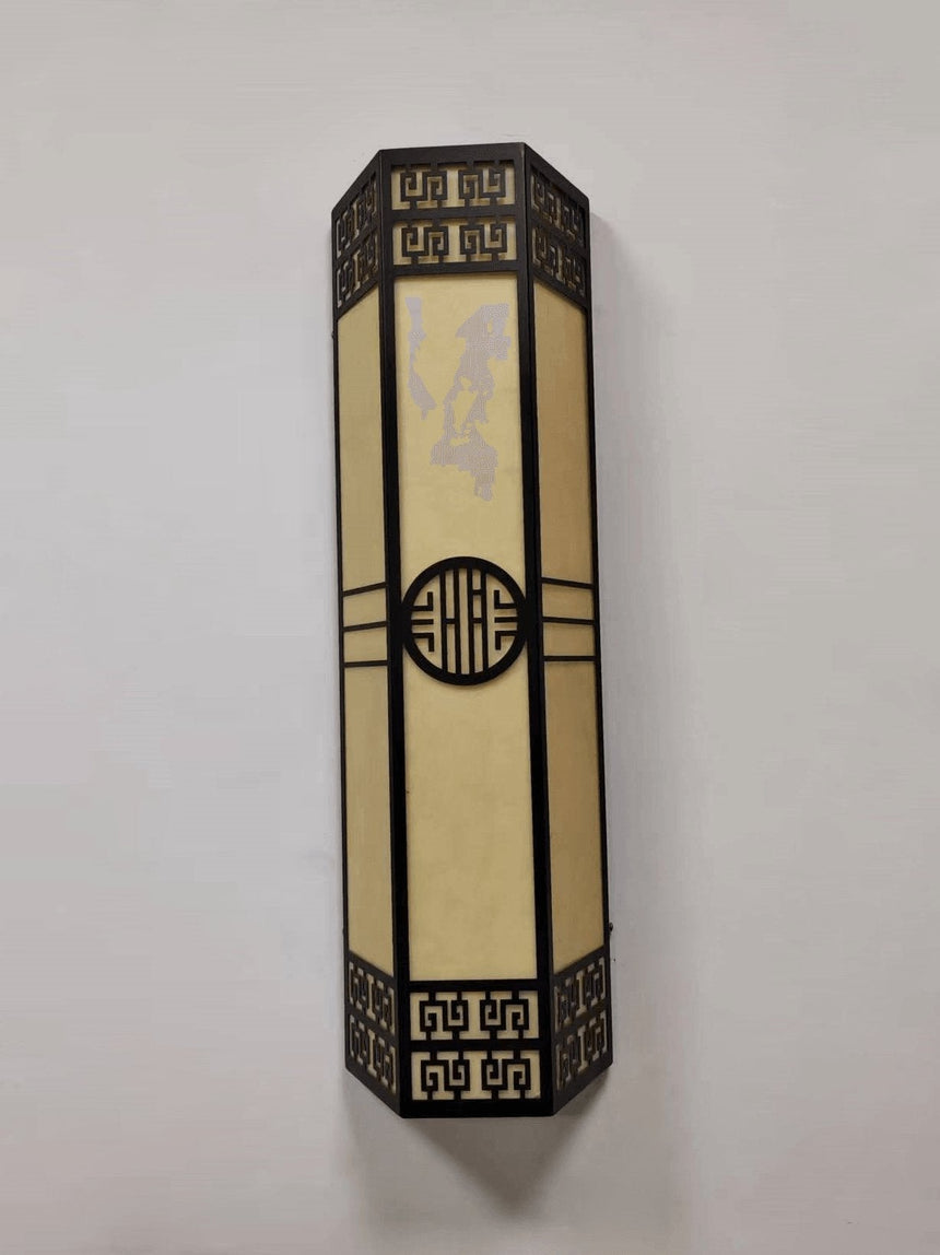 The light unlit on a pale wall, showing the veined cream panels behind the black frame