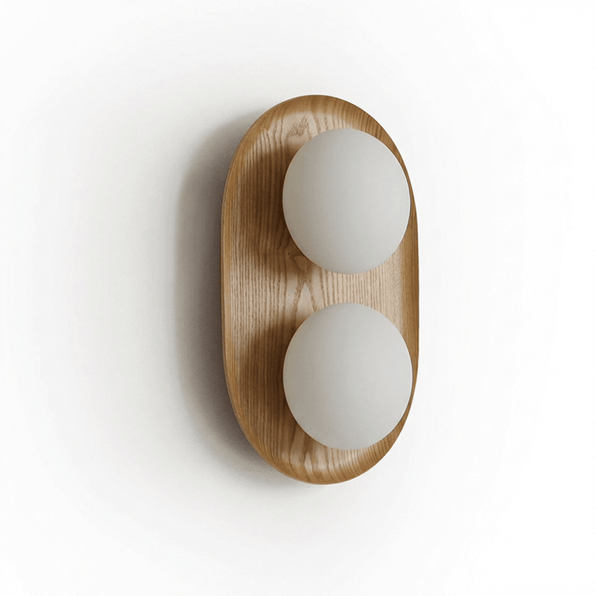 The wood capsule at an angle showing how the globes sit proud of the face