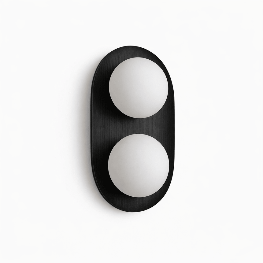 Black capsule with two opal globes set into its face, seen unlit