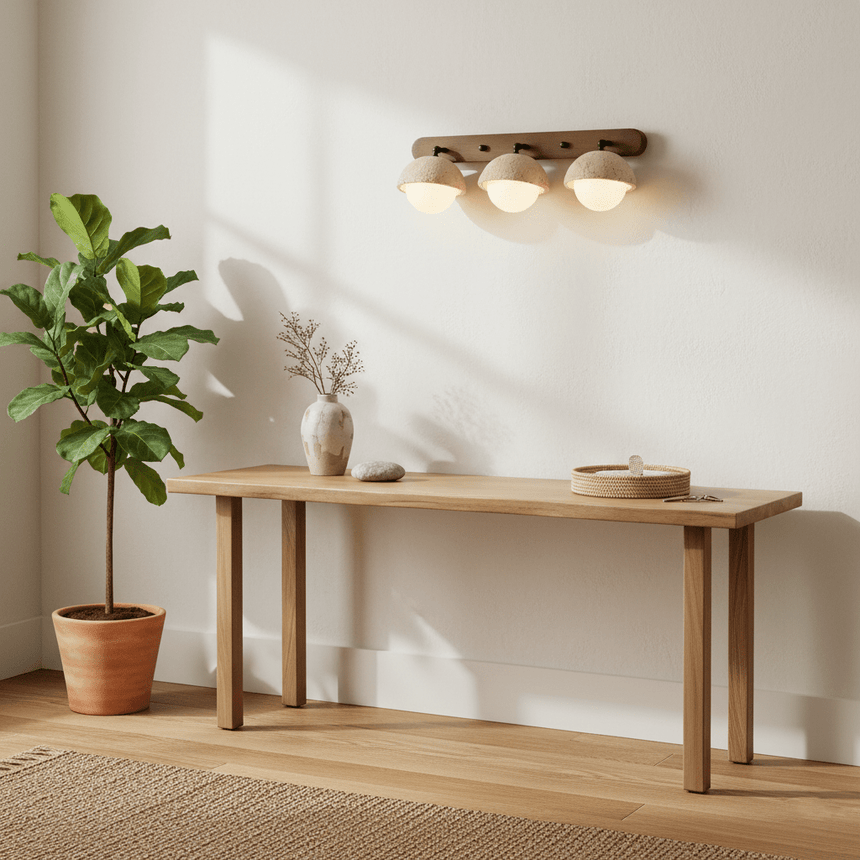 Two domes lit above a long wood console with potted plants either side