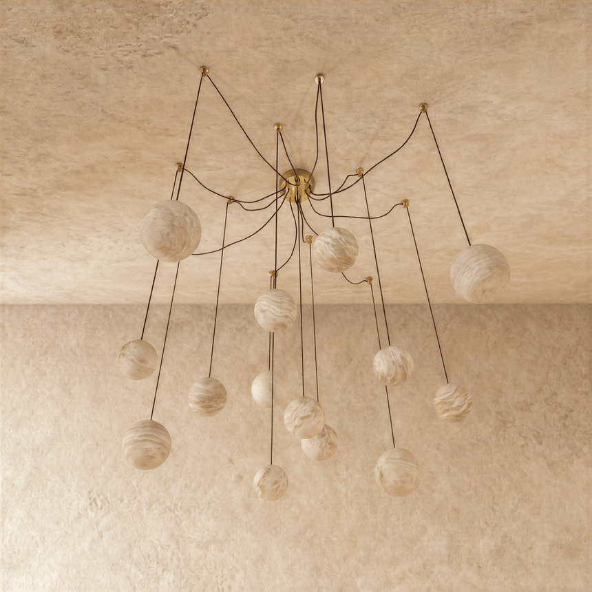 The globes unlit on brass arms, each stone sphere on its own curved stem