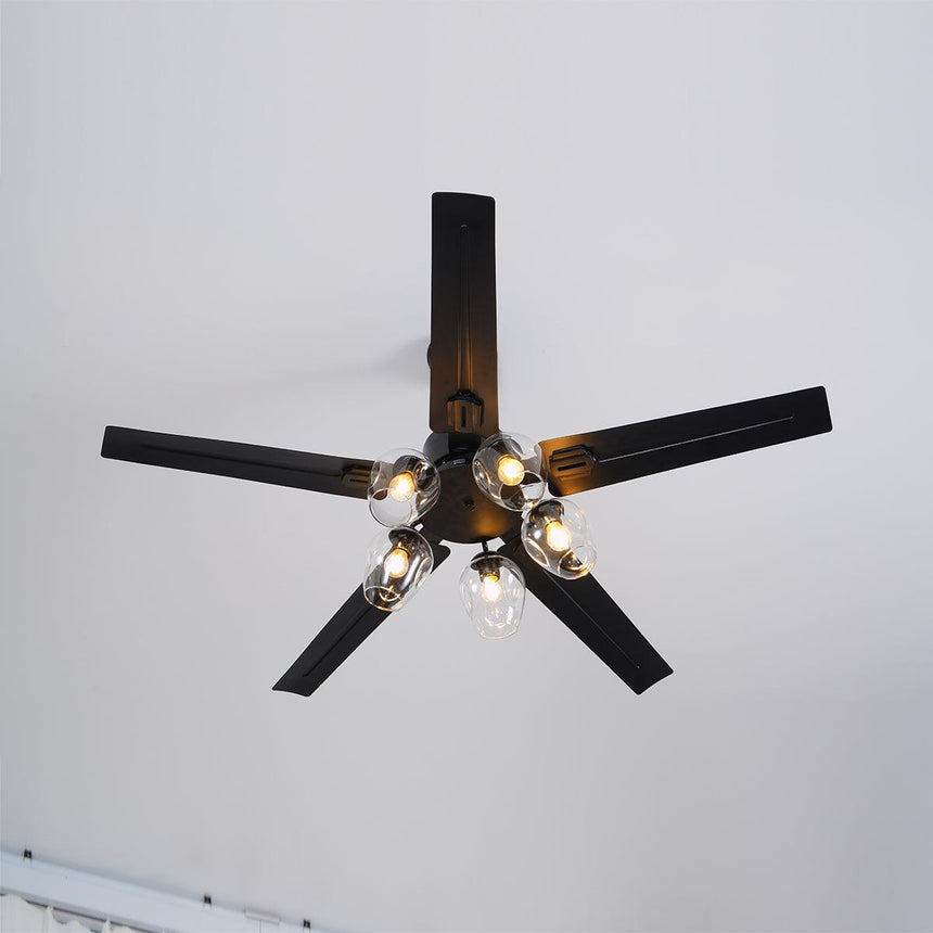 Black ceiling fan with glass globes seen at an angle