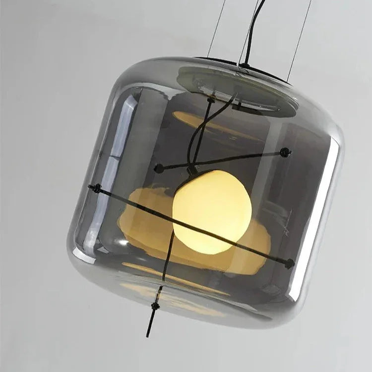 Close view of the opal sphere held inside the clear glass drum