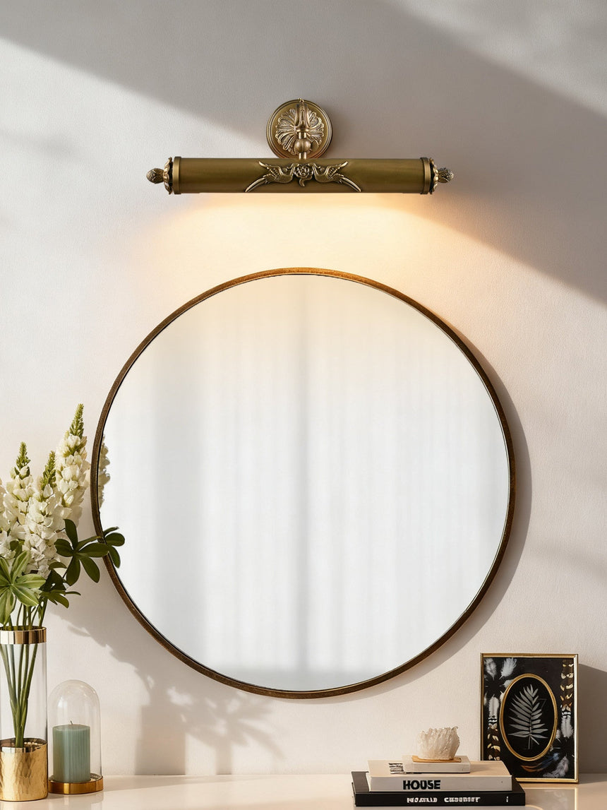 Scrolled brass bar above a round mirror over a console with books