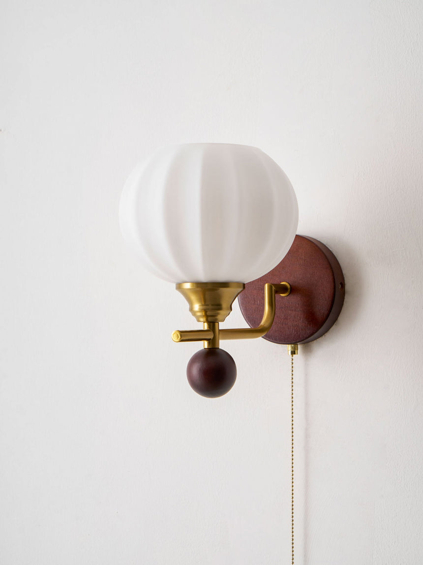 Close view of the ribbed white glass globe and the brass fittings