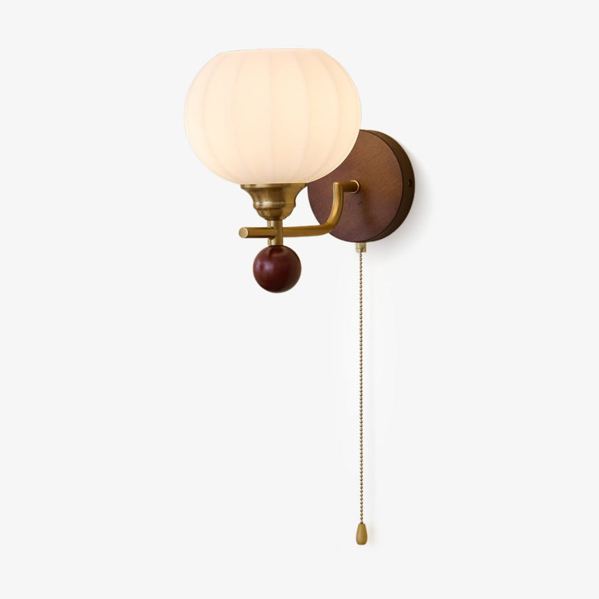 Ribbed white glass sconce unlit against a plain ground, pull chain down