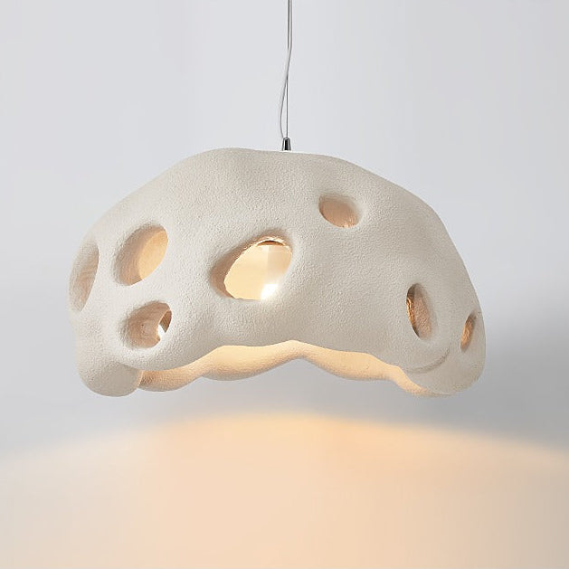 Cream perforated dome shade photographed against a pale ground