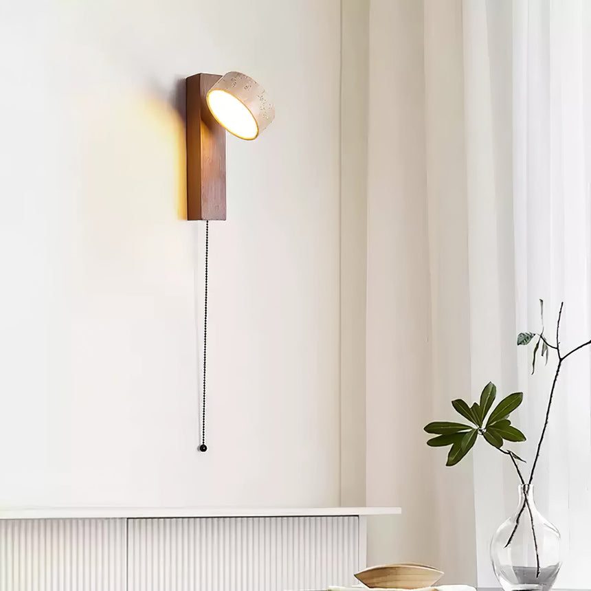 Lamp lit beside a window above a radiator with a plant in a stone pot