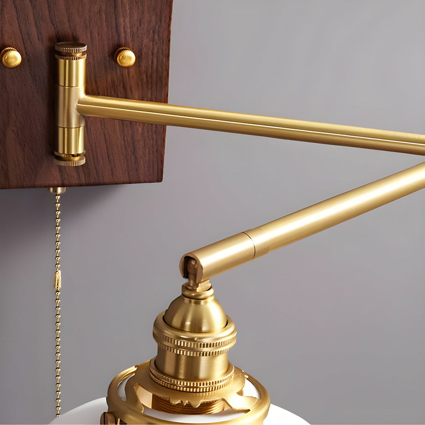 Close view of the brass elbow and the pull chain hanging beside it