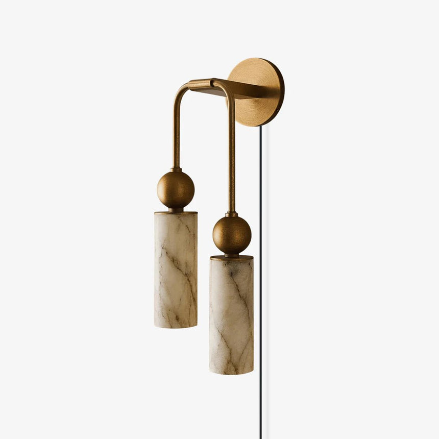 Two stone tubes on curved brass arms with a cord running down the wall