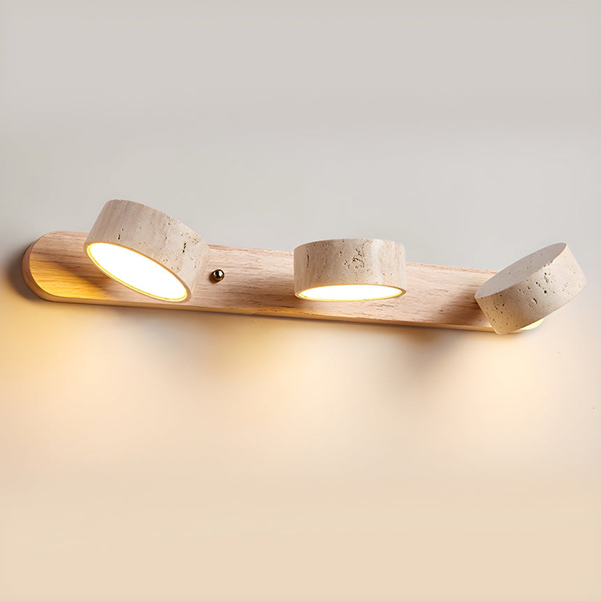 The four shade version lit at an angle, stone discs glowing along the wood bar