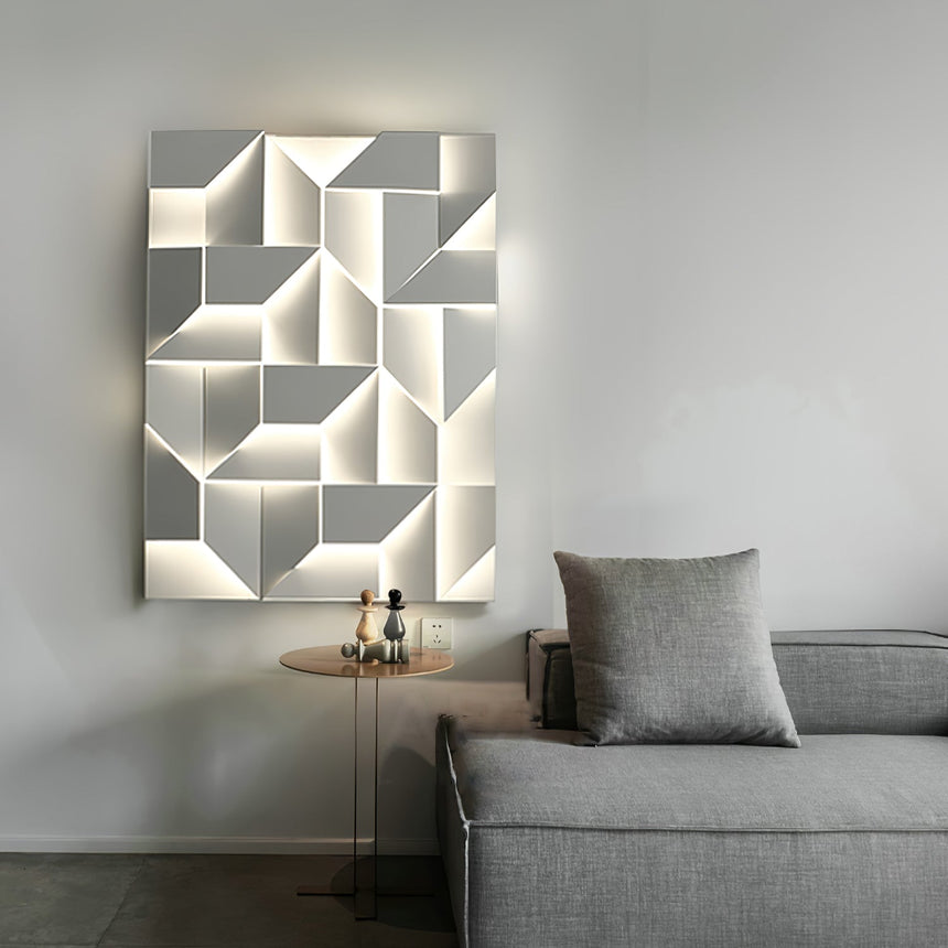 Lit above a gray sofa with a cushion and a small round side table alongside