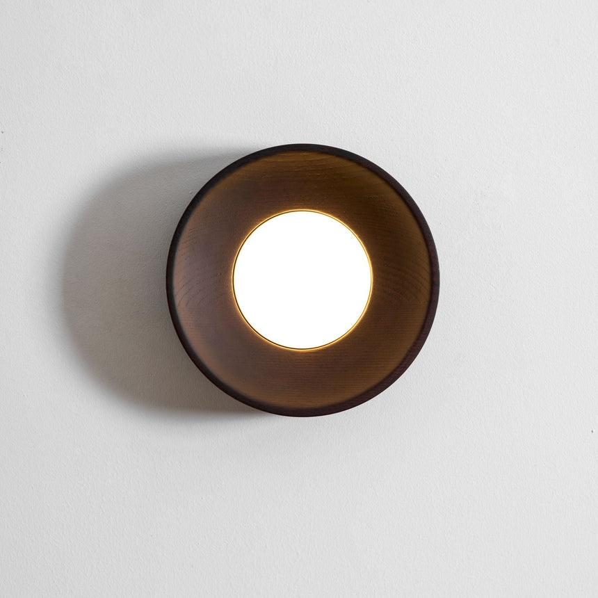 The drum in profile on a pale wall showing how shallow it sits