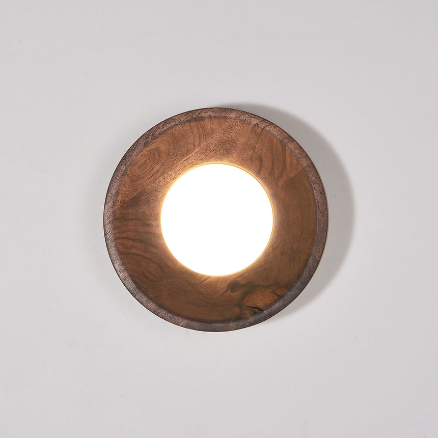 Walnut drum lit warm, the white disc recessed inside the straight rim