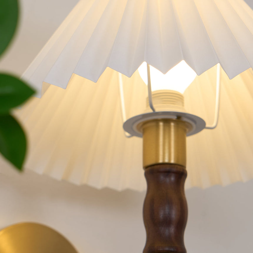 Looking up into the pleated shade at the brass fitting and the lamp