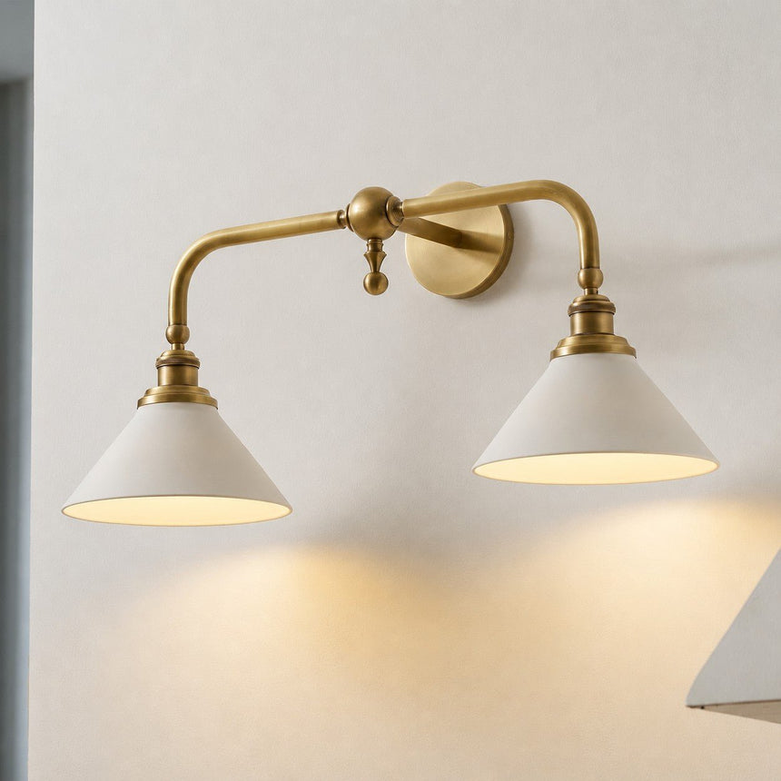 Close view of the double version lit, two white cones on a brass bridge arm