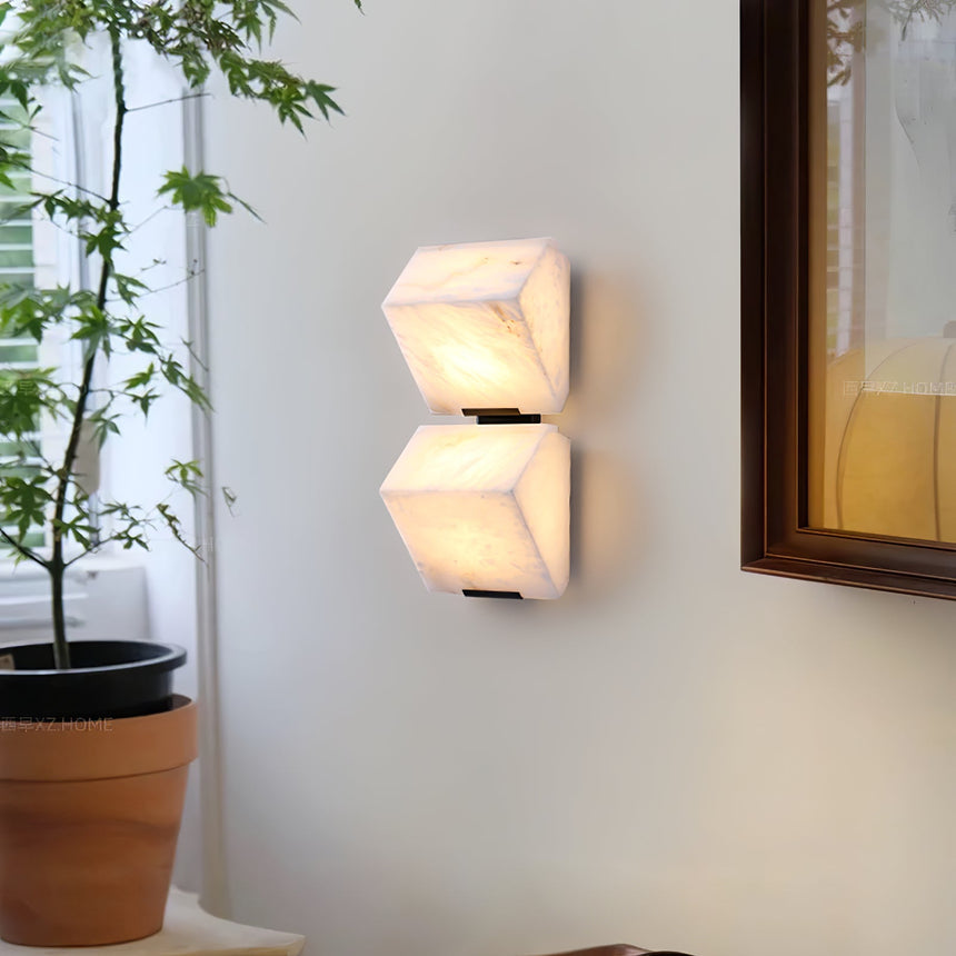 Two lit blocks near a window with a potted plant and a framed painting