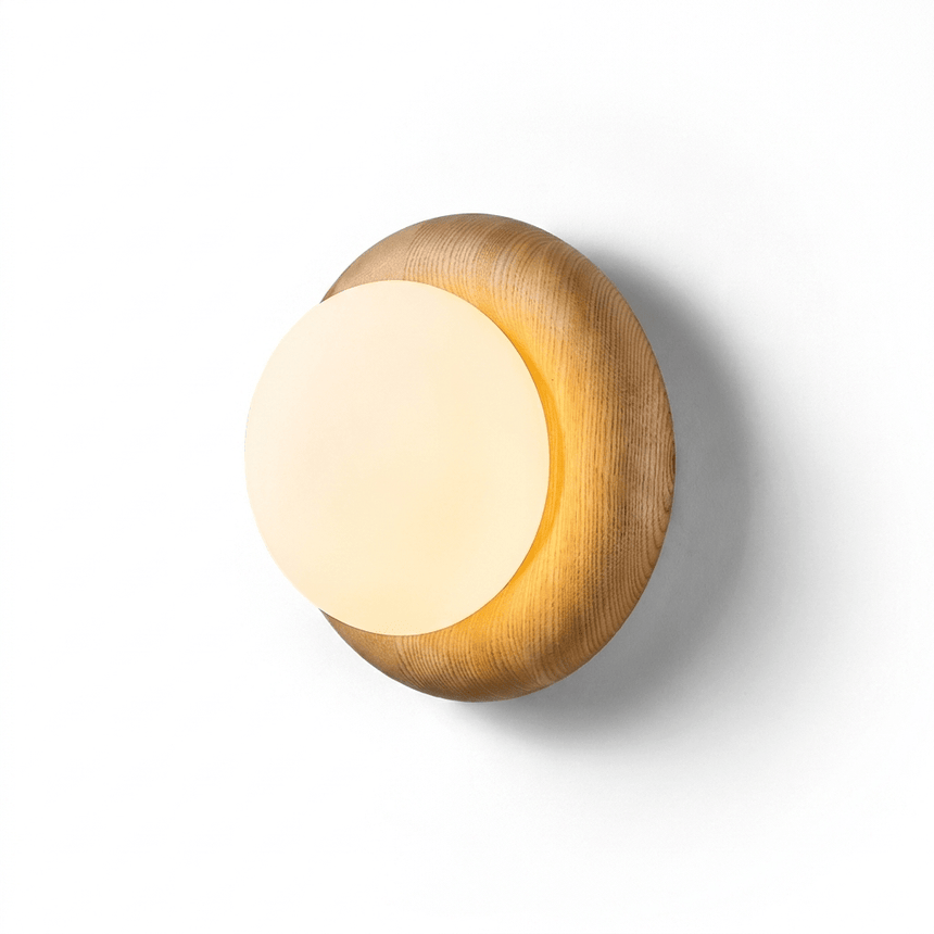 The lit fitting seen at an angle, the globe clear of the softened wood edge
