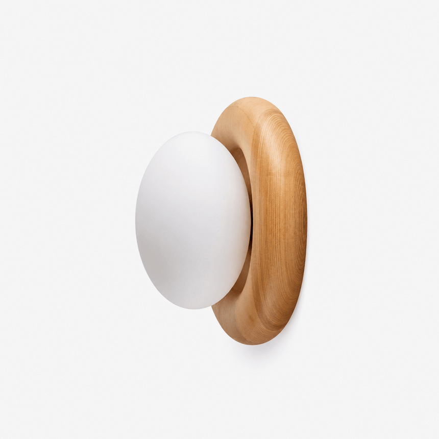 The fitting in profile, showing how little the wood disk stands off the wall
