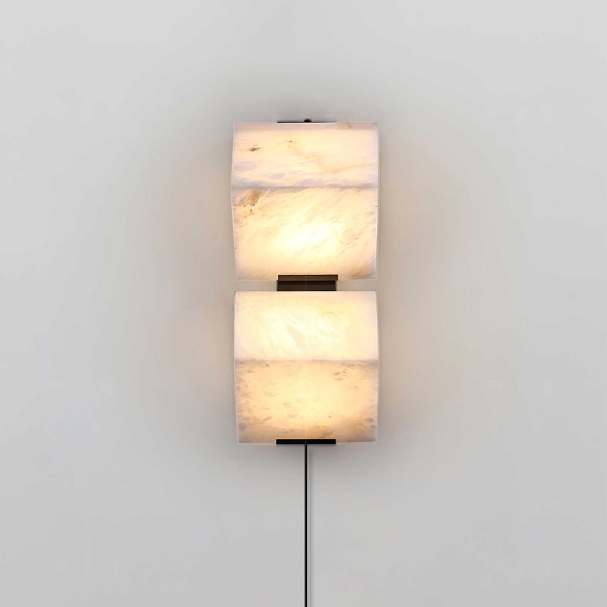 The two block lamp lit, the veins of the alabaster showing through the glow