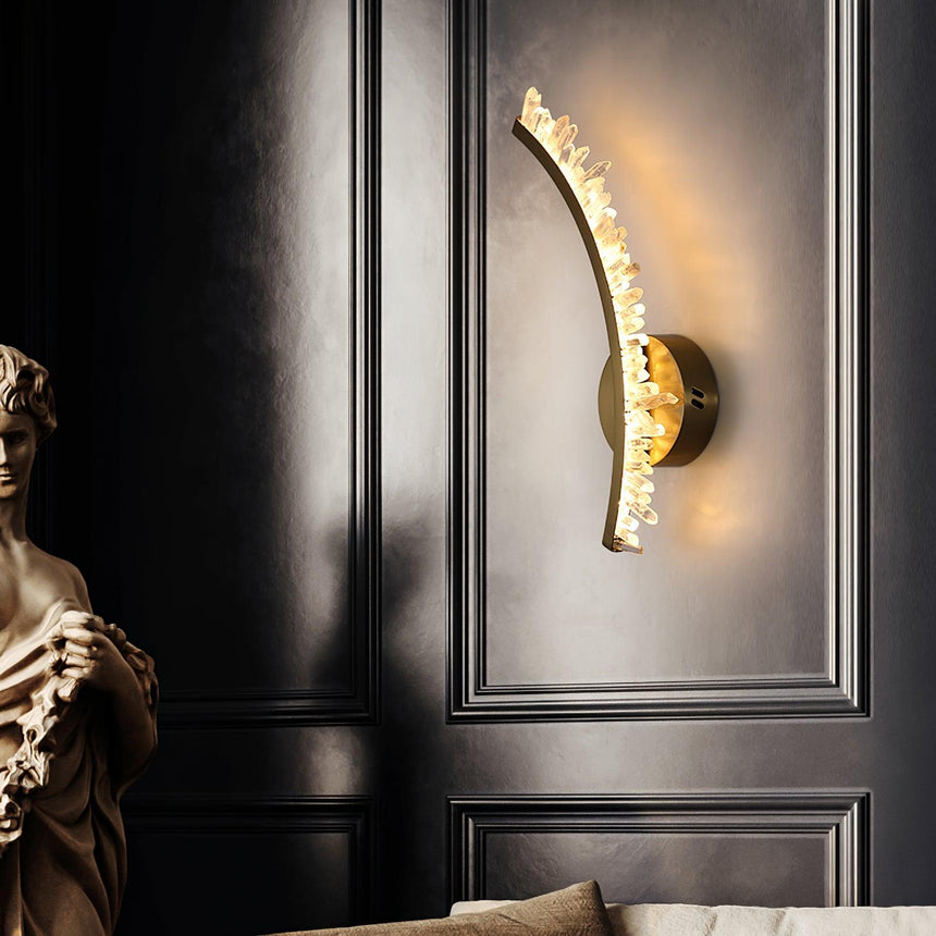 One curved arm lit on a black paneled wall beside a classical bust