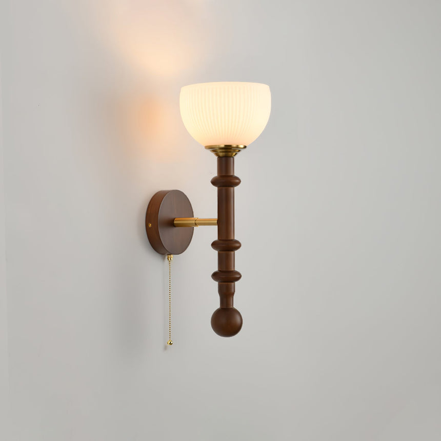 White glass tulip shade on a walnut column with a brass arm and pull chain