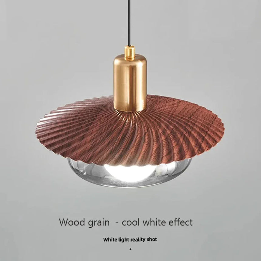 The disc lit with cool white light showing the smoked glass below the grain