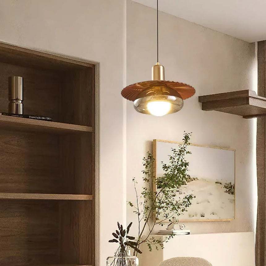 The walnut grain disc lit beside open shelves and a trailing plant