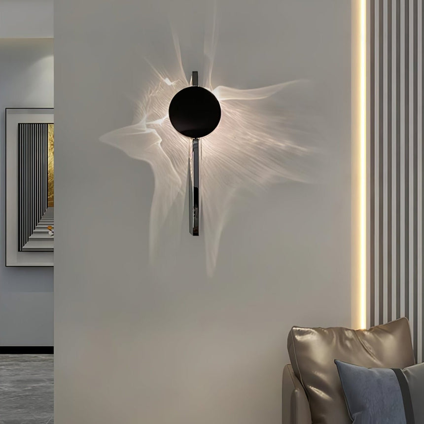 The single disc light lit above a leather armchair in a living room