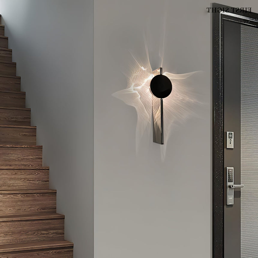 The single disc light lit beside a wood staircase and a front door