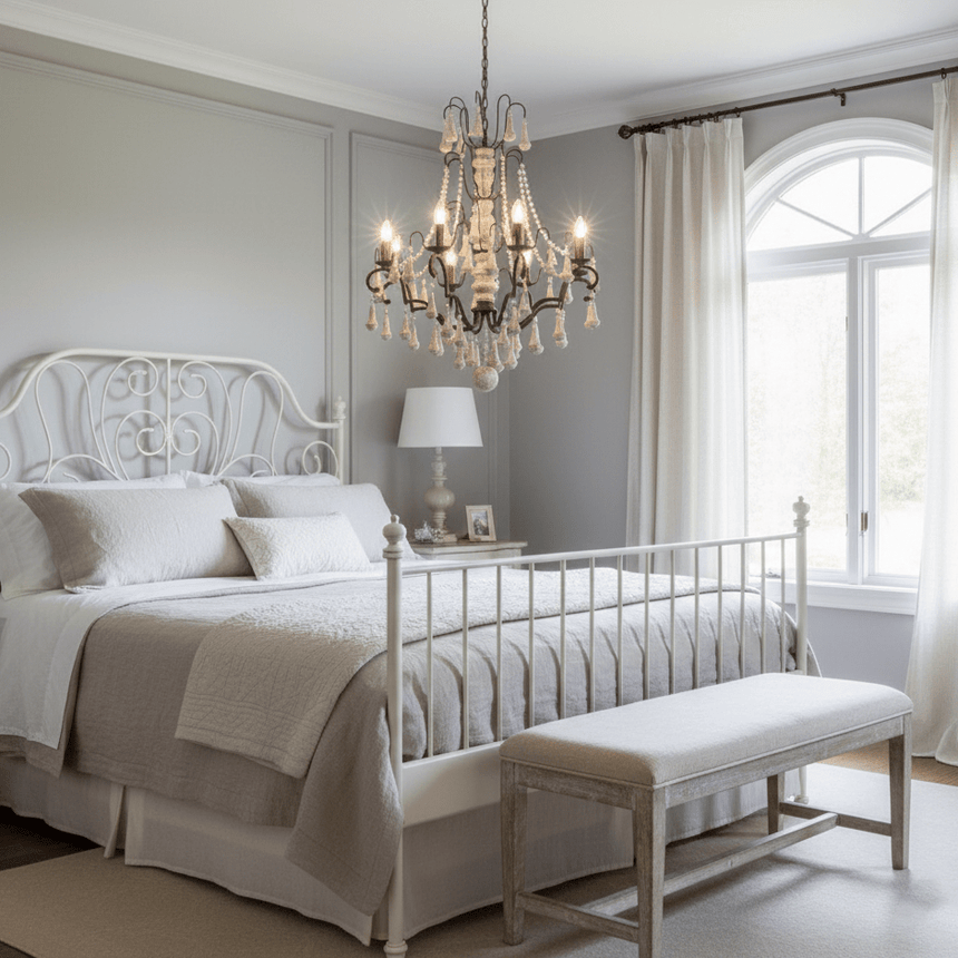 Lit above a white bed with an arched window and a bench at its foot