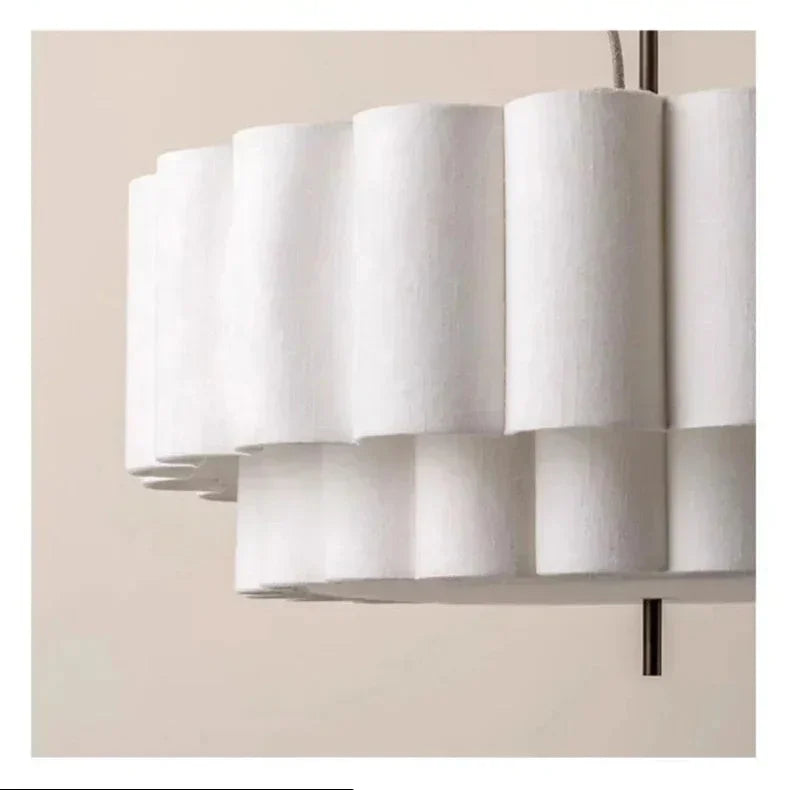 Close view of the rounded scalloped lobes on the white fabric drum shade